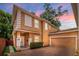 Two-story home with brick driveway, stucco exterior, and well-maintained landscaping at 1130 Hardy Ave, Orlando, FL 32803