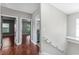 Hallway leads to bedrooms and bathroom with cherry-wood flooring at 1130 Hardy Ave, Orlando, FL 32803