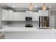 Beautiful kitchen showcasing a kitchen island, white cabinets, and stainless steel appliances at 1130 Hardy Ave, Orlando, FL 32803