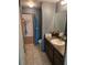 Bathroom with a vanity, decorative mirror and walk-in closet at 119 Stewart Lake Loop, Groveland, FL 34736