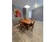 Cozy dining area with tile flooring, a wooden table, and decorative lighting fixture at 119 Stewart Lake Loop, Groveland, FL 34736