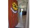 Inviting entryway with decorative wreath, leading into open-concept living area with tile flooring and kitchen view at 119 Stewart Lake Loop, Groveland, FL 34736