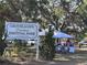 Groveland's Downtown Festival Park sign, showing gazebo and vendors for a community event at 119 Stewart Lake Loop, Groveland, FL 34736