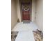 Inviting front entrance featuring a brown door adorned with a cheerful wreath and decorative accents at 119 Stewart Lake Loop, Groveland, FL 34736