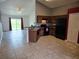 An open kitchen features wood cabinets, breakfast bar and black appliances with view into the living area at 119 Stewart Lake Loop, Groveland, FL 34736