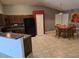 Open-concept kitchen and dining area with tile flooring and a granite countertop at 119 Stewart Lake Loop, Groveland, FL 34736