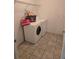 Laundry room with tile flooring, washer, dryer and shelving at 119 Stewart Lake Loop, Groveland, FL 34736