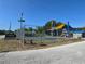 Exterior view of David Blanks Playground showing the play structures, basketball court, and fencing at 119 Stewart Lake Loop, Groveland, FL 34736