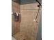 Tiled shower with detachable shower head, seating area, and recessed soap holder at 119 Stewart Lake Loop, Groveland, FL 34736