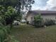 Side view of the home, showing the fenced in area and mature landscaping at 123 N High St, Lake Mary, FL 32746