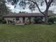 Spacious backyard featuring a lawn, patio furniture, and mature tree at 123 N High St, Lake Mary, FL 32746