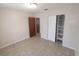 Bright bedroom features a closet with shelving and a neutral color palette at 123 N High St, Lake Mary, FL 32746