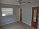 Bedroom showcases neutral walls, window with blinds, fan, and door with mirror at 123 N High St, Lake Mary, FL 32746