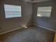 Bedroom with two windows, blinds, and neutral walls with baseboard at 123 N High St, Lake Mary, FL 32746