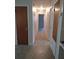 Hallway view featuring neutral paint and good lighting, connecting various rooms within the home at 123 N High St, Lake Mary, FL 32746