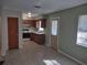 Clean kitchen with essential appliances and cabinets, connected to a bright and open living space at 123 N High St, Lake Mary, FL 32746
