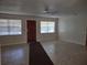 Bright living room featuring neutral paint, fan, and ample light from large windows at 123 N High St, Lake Mary, FL 32746