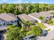 Aerial shot of a well-maintained home with lush landscaping, a paver driveway, and a manicured lawn at 1232 Turnbridge Pl, Oviedo, FL 32765