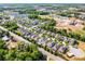 An aerial view of the neighborhood displays tree-lined streets and homes with spacious lawns in a suburban setting at 1232 Turnbridge Pl, Oviedo, FL 32765