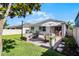 Spacious backyard with a patio, fire pit, dining area, and lush grass at 1232 Turnbridge Pl, Oviedo, FL 32765