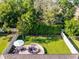 An aerial view shows a backyard with a patio, outdoor seating, and a meticulously maintained lawn at 1232 Turnbridge Pl, Oviedo, FL 32765