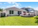 Backyard features a patio, fire pit, dining area, and lush grass at 1232 Turnbridge Pl, Oviedo, FL 32765