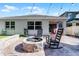 Inviting backyard patio featuring a brick fire pit, grill, and covered outdoor seating for relaxing and entertaining at 1232 Turnbridge Pl, Oviedo, FL 32765