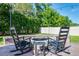 Cozy backyard patio with rocking chairs surrounding a brick fire pit, perfect for outdoor gatherings at 1232 Turnbridge Pl, Oviedo, FL 32765