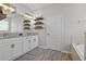 Bathroom with double sinks and floating shelves at 1232 Turnbridge Pl, Oviedo, FL 32765
