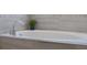 Close up of a modern soaking tub with gray marble tile surround at 1232 Turnbridge Pl, Oviedo, FL 32765