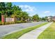 Community entrance sign at Lukas Landing with brick pillars, landscaping, and a secure gate at 1232 Turnbridge Pl, Oviedo, FL 32765