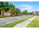 Gated community entrance with palm trees and lush landscaping at Lukas Landing at 1232 Turnbridge Pl, Oviedo, FL 32765