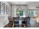 Well-lit dining room features a rustic wood table, black chairs, and sliding doors opening to an outdoor patio at 1232 Turnbridge Pl, Oviedo, FL 32765