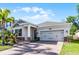 Well-maintained home featuring manicured landscaping and a brick paved driveway at 1232 Turnbridge Pl, Oviedo, FL 32765