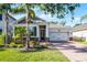 Charming home with a lush landscaped yard, brick pathway, and a two-car garage at 1232 Turnbridge Pl, Oviedo, FL 32765