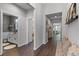 A spacious hallway featuring hardwood flooring with an open view of the living room at 1232 Turnbridge Pl, Oviedo, FL 32765
