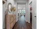 Inviting foyer with tile flooring, decorative mirror, and convenient coat rack storage at 1232 Turnbridge Pl, Oviedo, FL 32765