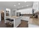 Bright kitchen featuring granite countertops, white cabinets, stainless steel appliances, and island with breakfast bar at 1232 Turnbridge Pl, Oviedo, FL 32765