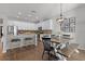 Open-concept kitchen and dining area with white cabinets, granite counters, and a cozy dining set near the window at 1232 Turnbridge Pl, Oviedo, FL 32765