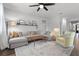 Bright living room with modern decor, a plush gray sectional sofa, and a stylish ceiling fan at 1232 Turnbridge Pl, Oviedo, FL 32765