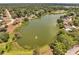 Aerial view of the neighborhood lake with waterfront homes and lush green surroundings at 1240 Pin Oak Dr, Apopka, FL 32703