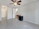 Neutral bedroom featuring gray tile flooring, ceiling fan, and closet space at 1240 Pin Oak Dr, Apopka, FL 32703