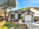 Charming single-story home with well-manicured lawn and attached garage at 1240 Pin Oak Dr, Apopka, FL 32703