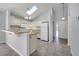 Bright eat-in kitchen with skylight, tile flooring, and white appliances at 1240 Pin Oak Dr, Apopka, FL 32703