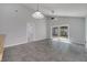 Open-plan living room with gray tile flooring and sliding glass doors at 1240 Pin Oak Dr, Apopka, FL 32703