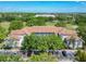 Overhead of a condominium with lush landscaping, parking, and a red tile roof at 13839 Fairway Island Dr # 1116, Orlando, FL 32837