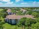 Overhead view of condominium complex featuring balconies and mature trees at 13839 Fairway Island Dr # 1116, Orlando, FL 32837