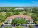 Aerial view of condominium with lush green landscaping and ample parking at 13839 Fairway Island Dr # 1116, Orlando, FL 32837