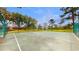 Fenced in basketball court surrounded by mature trees and community buildings at 13839 Fairway Island Dr # 1116, Orlando, FL 32837