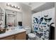 Bright bathroom featuring a single sink vanity and a shower with a butterfly themed curtain at 13839 Fairway Island Dr # 1116, Orlando, FL 32837